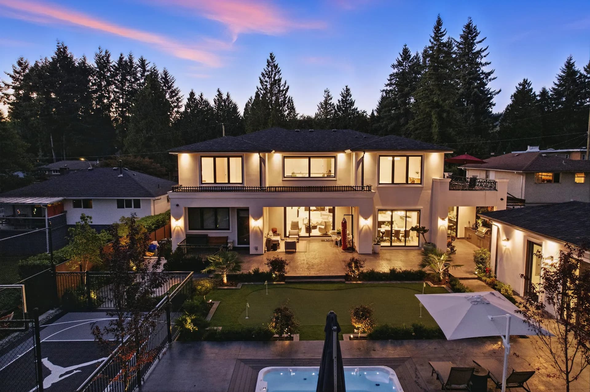 A lit modern home at twilight, photographed by AFK Media
